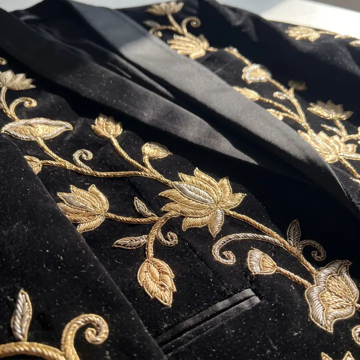 Detail: gold zardozi lotus embroidery on black velvet lapel