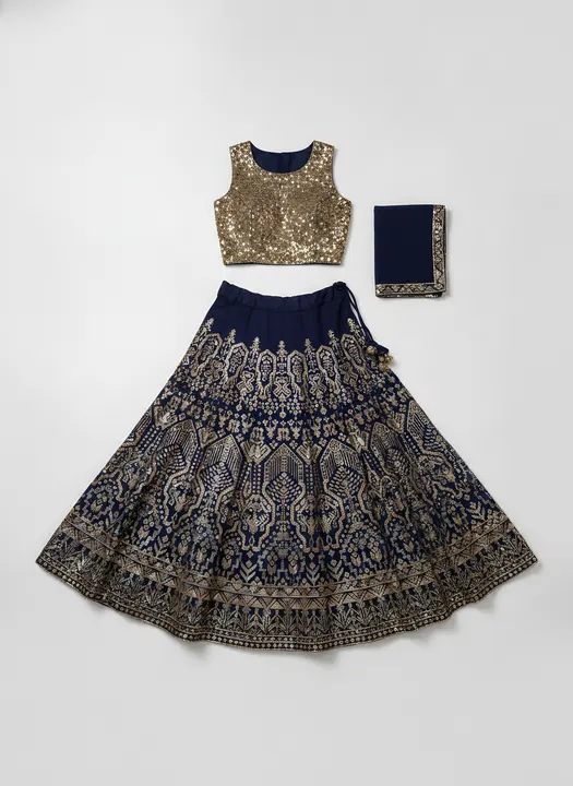 Flat-lay: gold blouse, navy dupatta and embroidered lehenga on grey