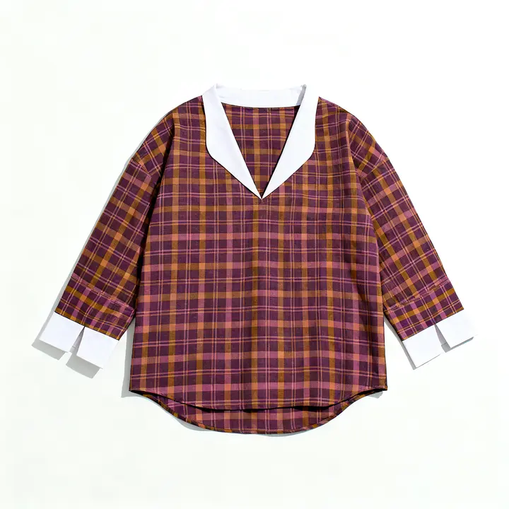 Flat-lay of the Sabki Madras check shirt on white, white collar and white split cuffs, curved hem.